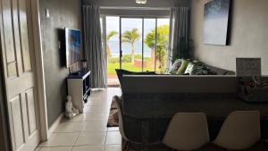 a living room with a couch and a table and a television at Cassa De La Luna Diossa in Kingsburgh