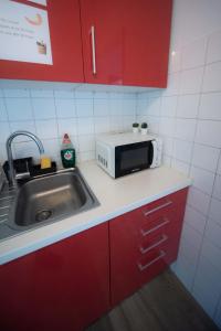 a kitchen with a sink and a microwave at By Port Vell Rooms in Barcelona