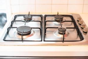 a stove top oven with four burners on it at By Port Vell Rooms in Barcelona