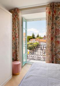 ein Schlafzimmer mit einem Bett und einem großen Fenster in der Unterkunft Apartamentos La Colonia de Muros in Muros de Nalón
