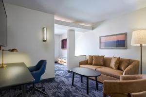 a living room with a couch and a table at Fairfield Inn and Suites by Marriott Winchester in Winchester