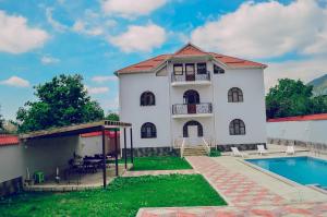 a house with a swimming pool in front of it at Gabala Regnum Family Villa in Gabala