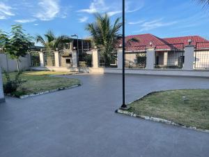 a courtyard with a building and a pole at West Coast Villa in Limbe