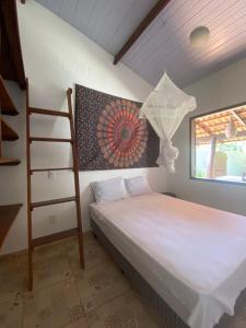 1 dormitorio con cama y escalera junto a una ventana en Little Kamala, en Pipa