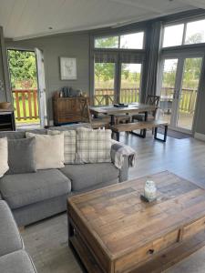 a living room with a couch and a coffee table at Glasshouse lodge 