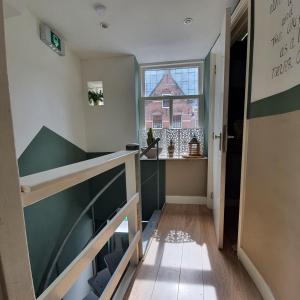 a room with a staircase and a window at City Attic Haarlem in Haarlem +26 photos