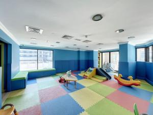 a childrens room with a table and a play area at Time Place Tower - Vacationer in Dubai