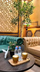 a table with two bowls and bottles of water on it at Levant Hotel in Najran