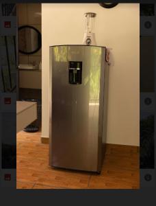 a stainless steel refrigerator sitting in a room at CASA KENJY in Quepos