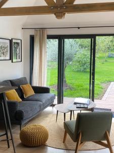 a living room with a couch and a table at LE CLOS DAUPHINAIS Chez Laurette in Quévert