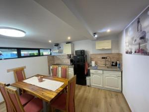 eine Küche mit einem Holztisch und einem Esszimmer in der Unterkunft Morrison Apartments in Miercurea Ciuc