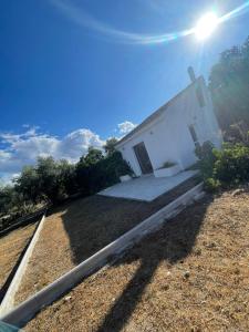 a small white building with the sun in the sky at Casa Martínez in Baza