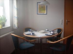 a small table with chairs and a table and a window at Ferienwohnung Schäfer in Waldbreitbach