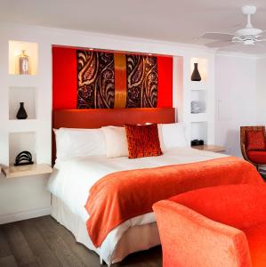 a bedroom with a large bed with a red headboard at Triada Palm Springs, Autograph Collection in Palm Springs