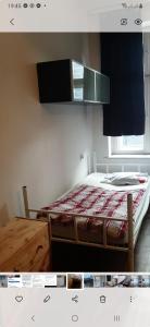 a small bedroom with a bed and a window at Pokoje ABC Centrum in Gdynia