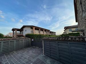 a house with a fence in front of it at Bes Residence Bergamo Polaresco in Bergamo