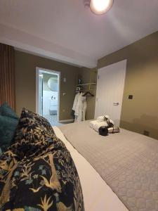 a bedroom with a bed with a phone on it at Stylish Kent Gem - Free WiFi in Kent