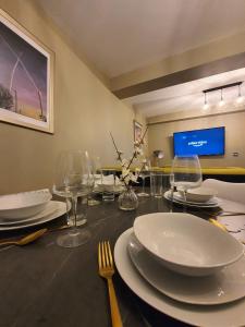 a dining room table with plates and glasses on it at Stylish Kent Gem - Sleeps 6 in Kent