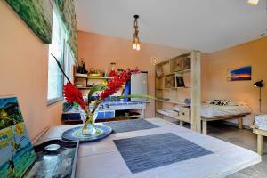 a room with a table with a vase with red flowers at Cabarete Boutique Kite Hotel for up to 15 people in Cabarete