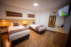 Katil atau katil-katil dalam bilik di Ayni Cusco Hotel
