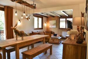 a living room with a table and a couch at Chalet la Dransette in Châtel