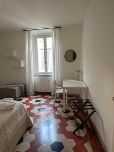a bedroom with a bed and a table and a window at Number 99 - Number House in Bergamo