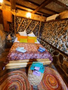 a bedroom with a bed with colorful pillows and blankets at Casa María Vivienda Vacacional in Adeje