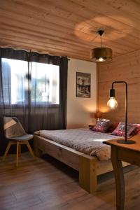 1 dormitorio con 1 cama, 1 mesa y 1 silla en Chalet la Dransette en Châtel
