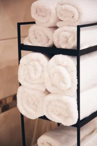 a stack of towels on a towel rack at Mono Boutique Apartments in Tirana