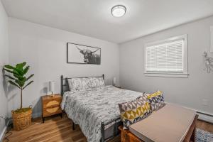 a bedroom with a bed and a couch at Cozy Condo Near Downtown! in Louisville