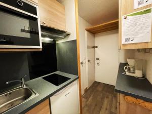 a small kitchen with a sink and a counter top at Studio Les Menuires, 1 pièce, 4 personnes - FR-1-452-195 in Les Menuires