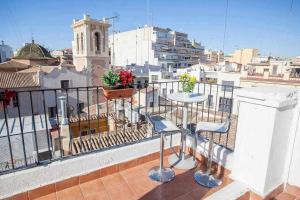 a balcony with two chairs and a table on a balcony at Valencia Apartamento centro old town in Valencia