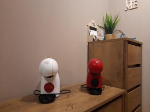 two robots are sitting on a wooden dresser at FOTIADIS BOUTIQUE RООМS and STUDIOS in Veliko Tŭrnovo