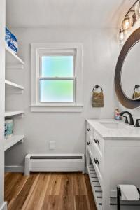 a bathroom with a sink and a window at Cozy Condo Near Downtown! in Louisville