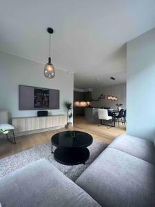 sala de estar con sofá y mesa en Sentrums-nær leilighet med sjøutsikt en Bergen