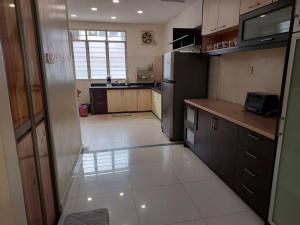 a kitchen with a refrigerator and a tile floor at Home in Gelugor4R3B Dnaz Homestay@Sg. Dua in Gelugor