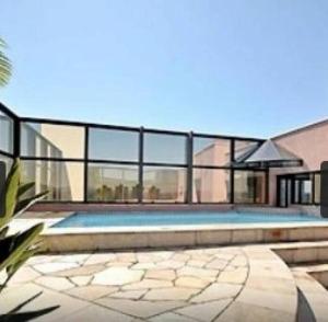 a swimming pool in the middle of a house at Apart Hotel 48 in Mogi das Cruzes