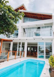 an exterior view of a house with a swimming pool at Casa Cancun Eventos e Hotel Boutique in Penha