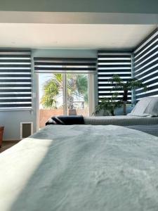 a bedroom with a bed and a large window at Departamento Beto in Tijuana
