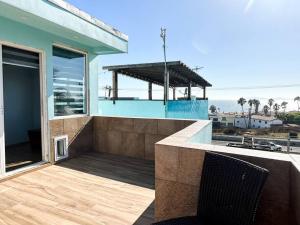 a house with a balcony with a view of the ocean at Departamento Beto in Tijuana +11 photos