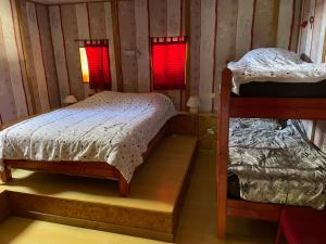 1 dormitorio con 2 literas y 2 ventanas en Espace Famille Montmillon, en Chamblay