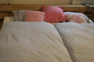 a bed with two pillows and a blanket on it at Ferienwohnung Himmel in Oberstaufen