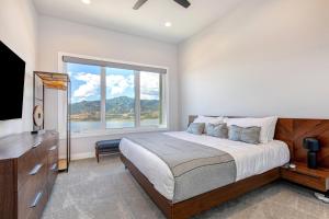 a bedroom with a bed and a large window at On Top of the Mountains - Full Townhome in Keetley