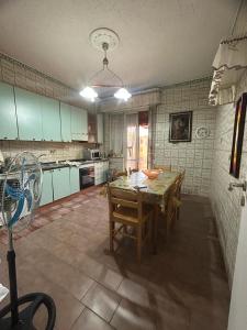 a kitchen with a table and chairs in it at CASA VACANZA BELVEDERE in Ercolano