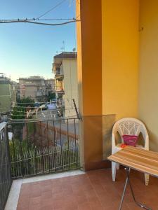 a bench on a balcony with a view of a city at CASA VACANZA BELVEDERE in Ercolano
