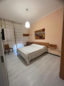 a bedroom with a bed and a television in it at CASA VACANZA BELVEDERE in Ercolano +1 photo