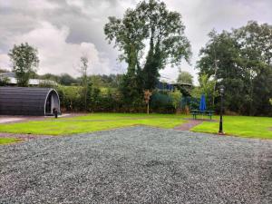 a park with a bench and a grass field at Gateway Glamping in Farranfore