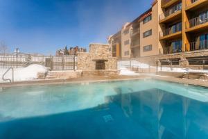 a large swimming pool in front of a building at Snow Flower 206 in Steamboat Springs