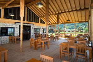 an empty restaurant with wooden tables and chairs at MUKHA ORMANLI in Ormanlı