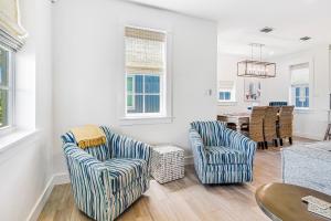 a living room with two chairs and a table at Kahakai Retreat in Port Aransas